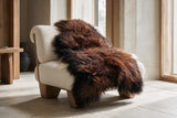 Natural brown and black Icelandic sheepskin draped over a luxury chair
