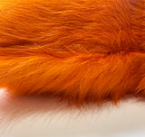 Close-up of Valencia orange cowhide showing natural hair-on-hide texture