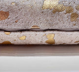 Metallic gold cowhide pillow detail showing hidden zipper and double-sided cowhide