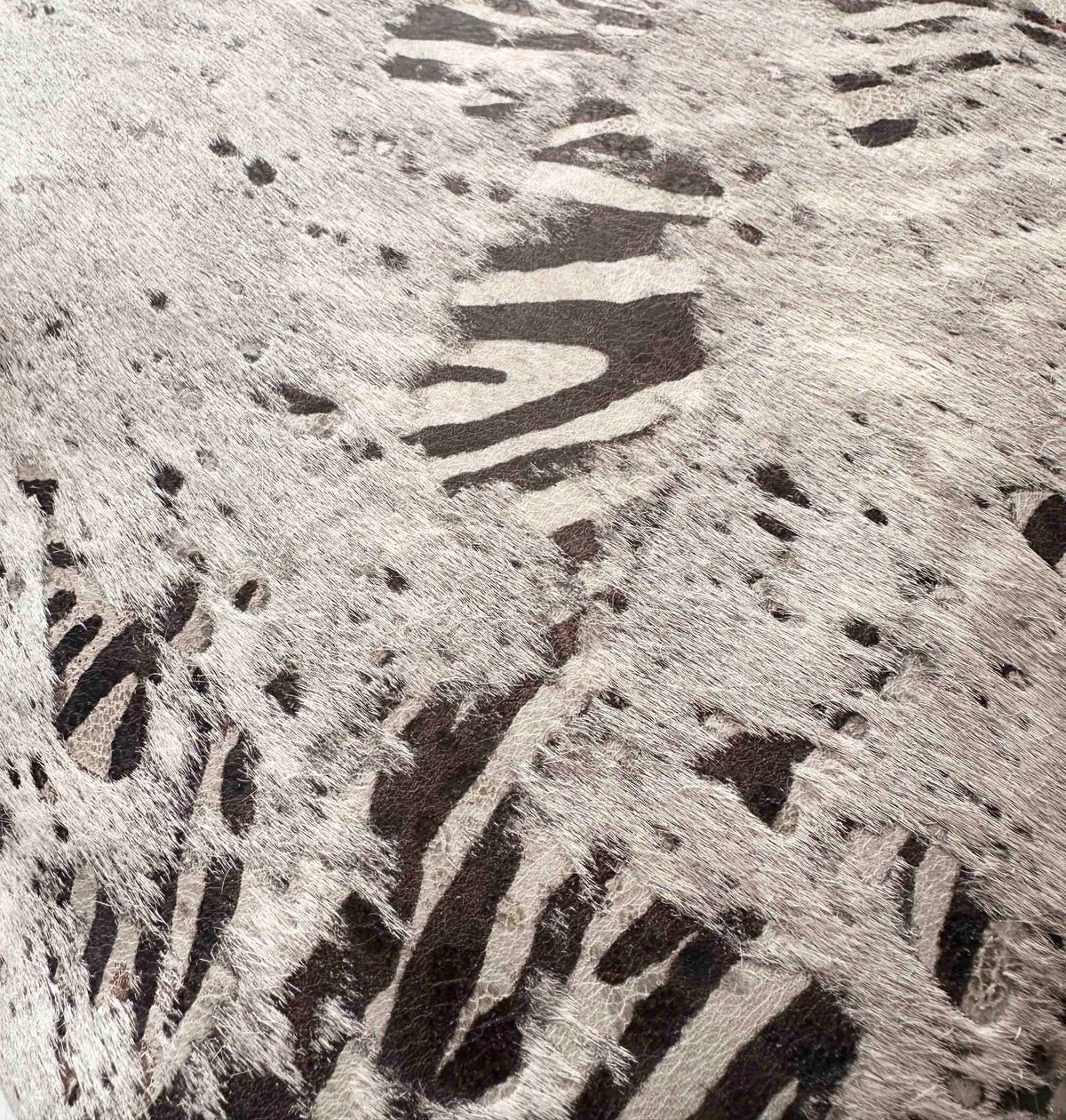 Detail of zebra serigraph pattern applied to genuine gray cowhide