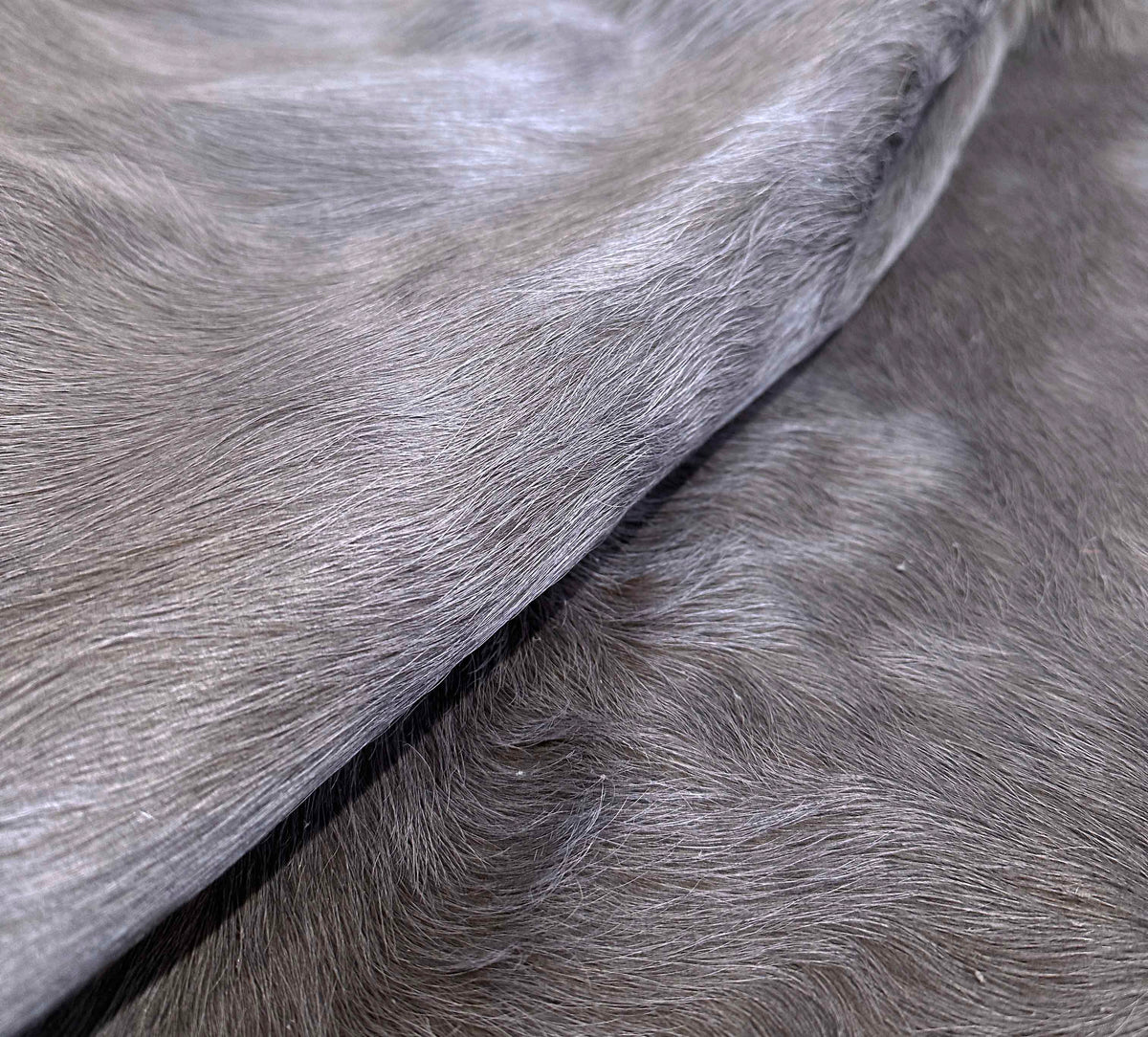 Close-up of dusty lilac dyed cowhide showing natural hair texture and subtle tonal variation