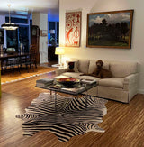 Living room with a sectional sofa, coffee table, and zebra print rug.