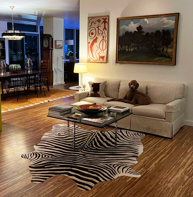 Living room with a sectional sofa, coffee table, and zebra print rug.
