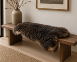 Luxury long wool sheepskin rug draped over wooden bench