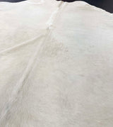 Close-up of a white cowhide rug with visible texture