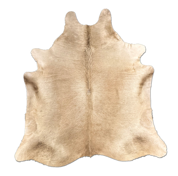 Beige cowhide rug on a white background