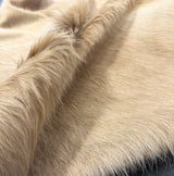 Close-up of beige cowhide fur texture