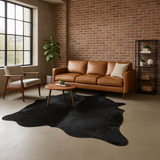 black cowhide rug on concrete floor