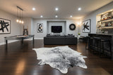 staged black white cowhide rug