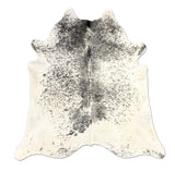 Spotted cowhide rug on a white background