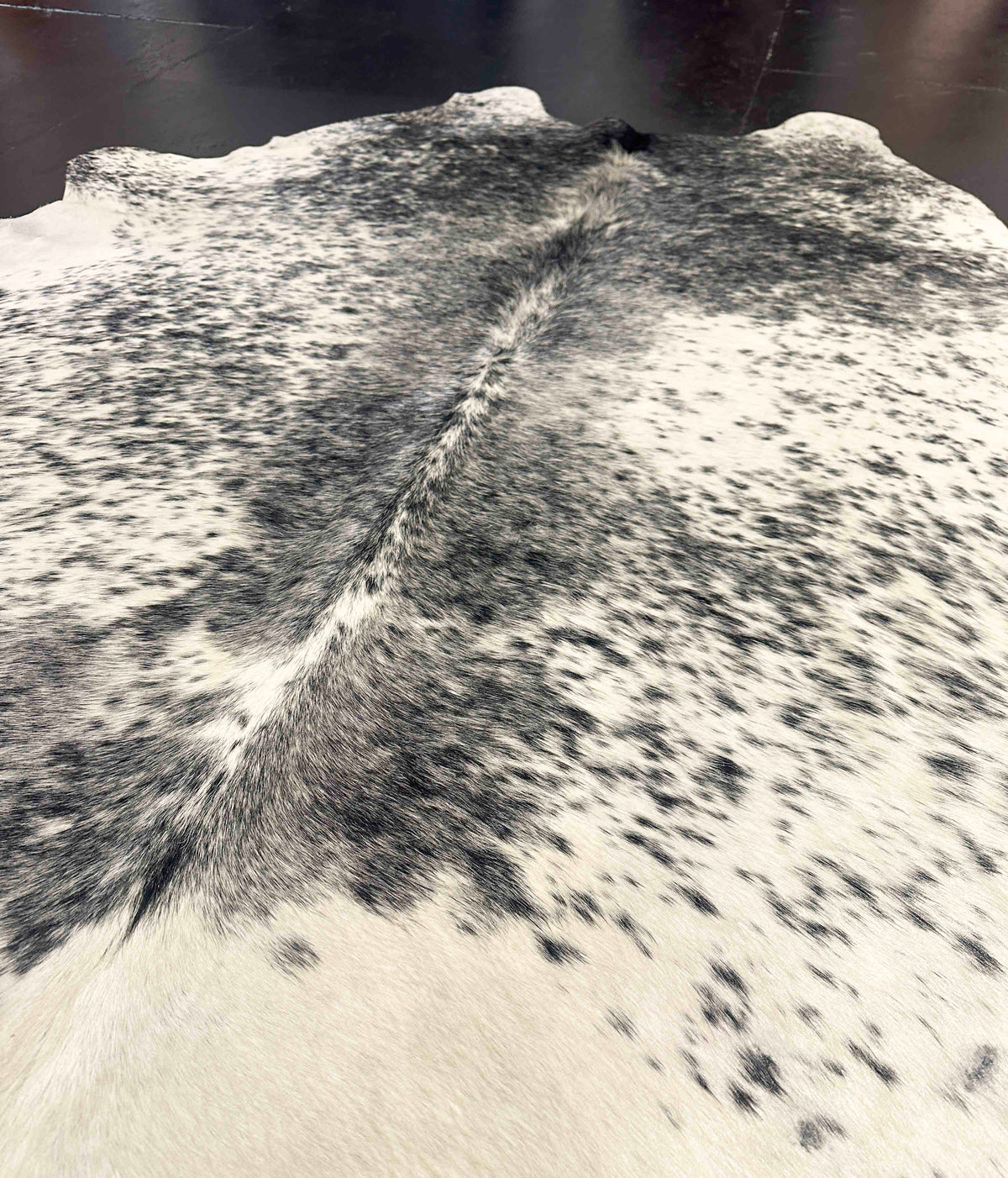 Close-up of a cowhide rug with black and white pattern