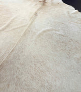 Close-up of a light brown cowhide rug fur texture
