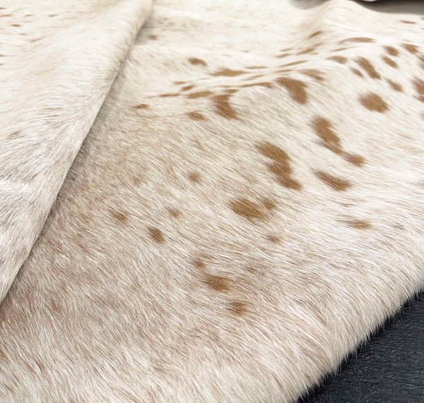 brown white cowhide rug