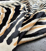Close-up of a zebra cowhide rug on a dark surface