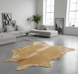 yellow cowhide rug on concrete floor