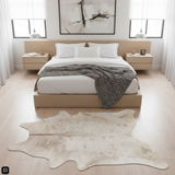 Modern bedroom with a cowhide rug on the floor.