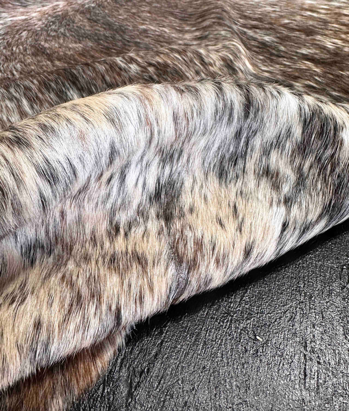 close-up of a tri-color cowhide rug