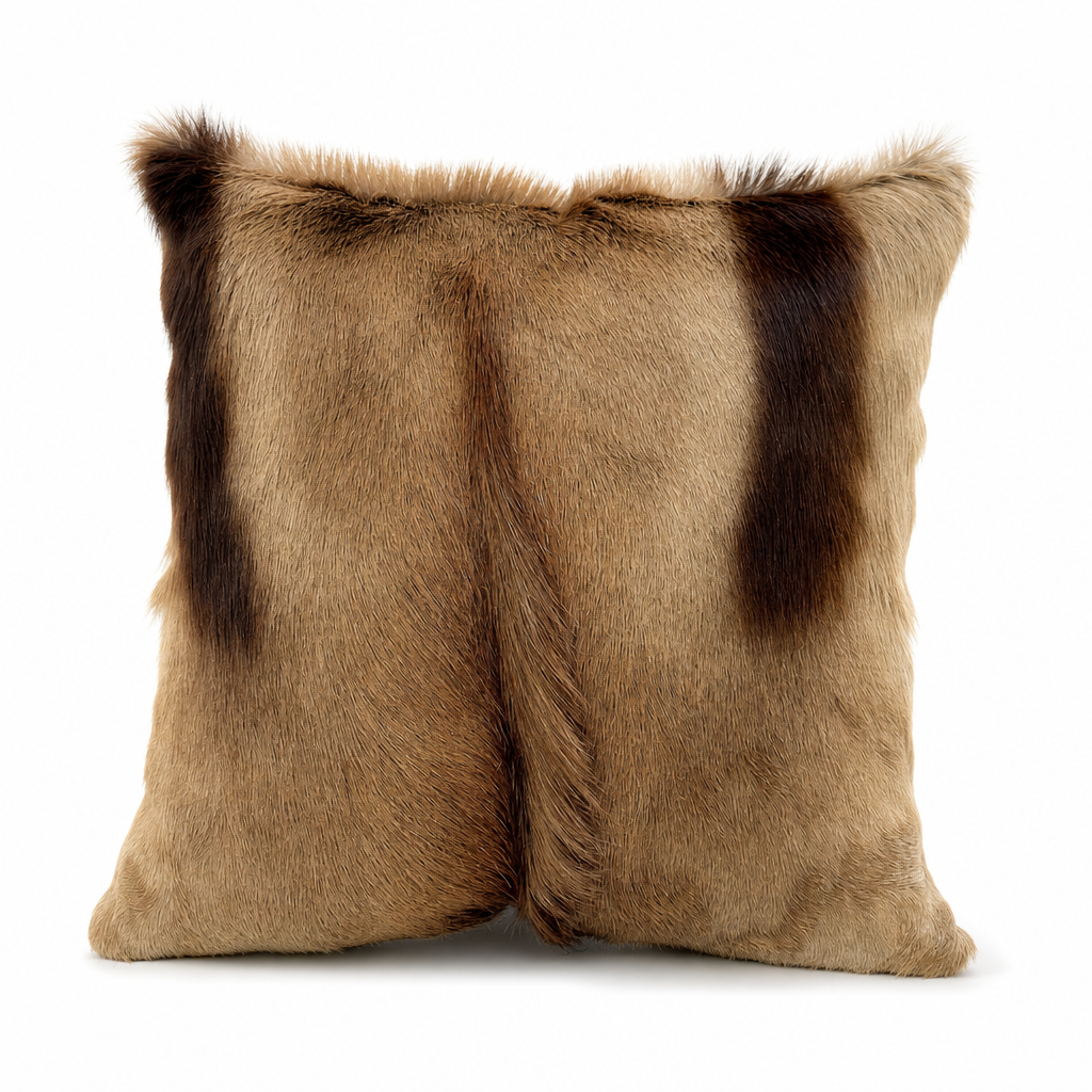 Genuine African copper springbok hide pillow, 17 x 17 inches, featuring natural champagne-copper fur and dark chocolate markings on a white background.