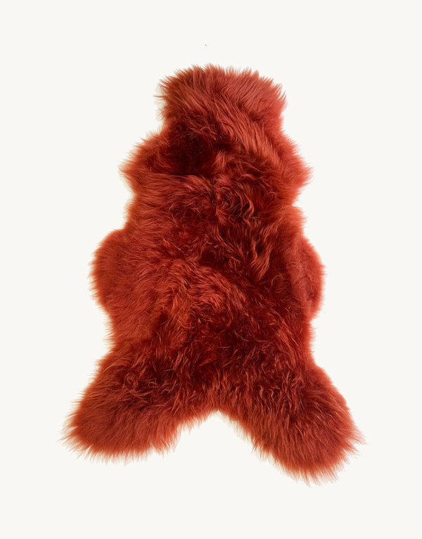red sheepskin rug