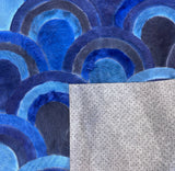 Underside of the Ocelli stitched cowhide rug showing gray felt backing with nonslip grip dots
