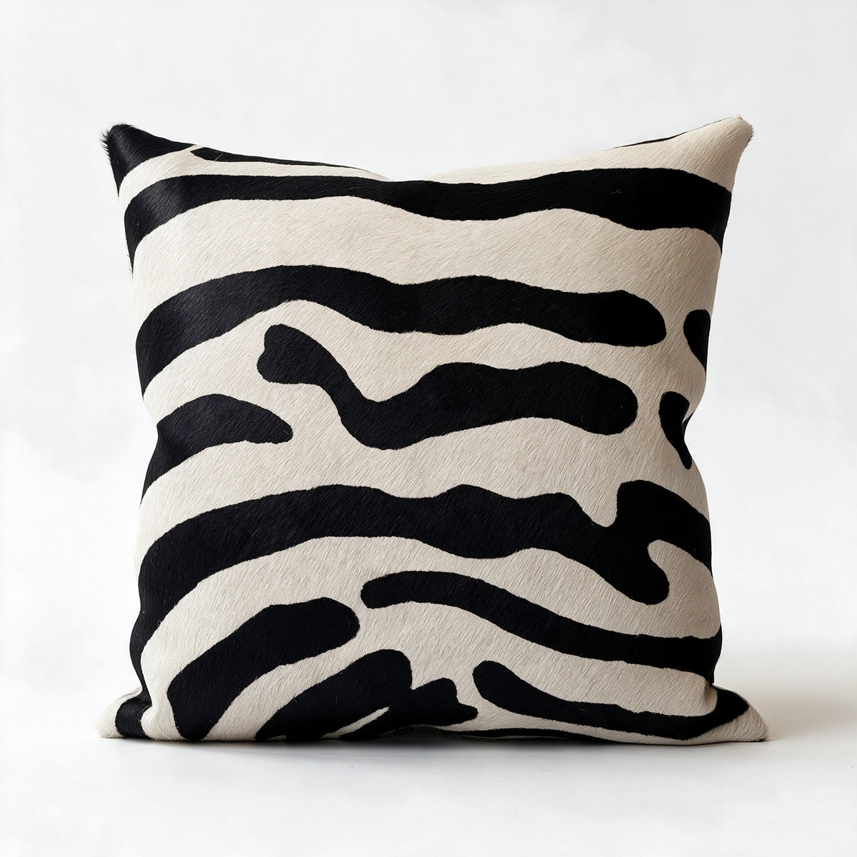 Stenciled zebra cowhide pillow in black and natural ivory hair-on-hide