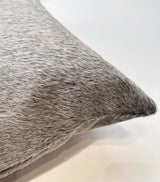 Close-up of natural gray cowhide pillow showing undyed hair-on-hide texture