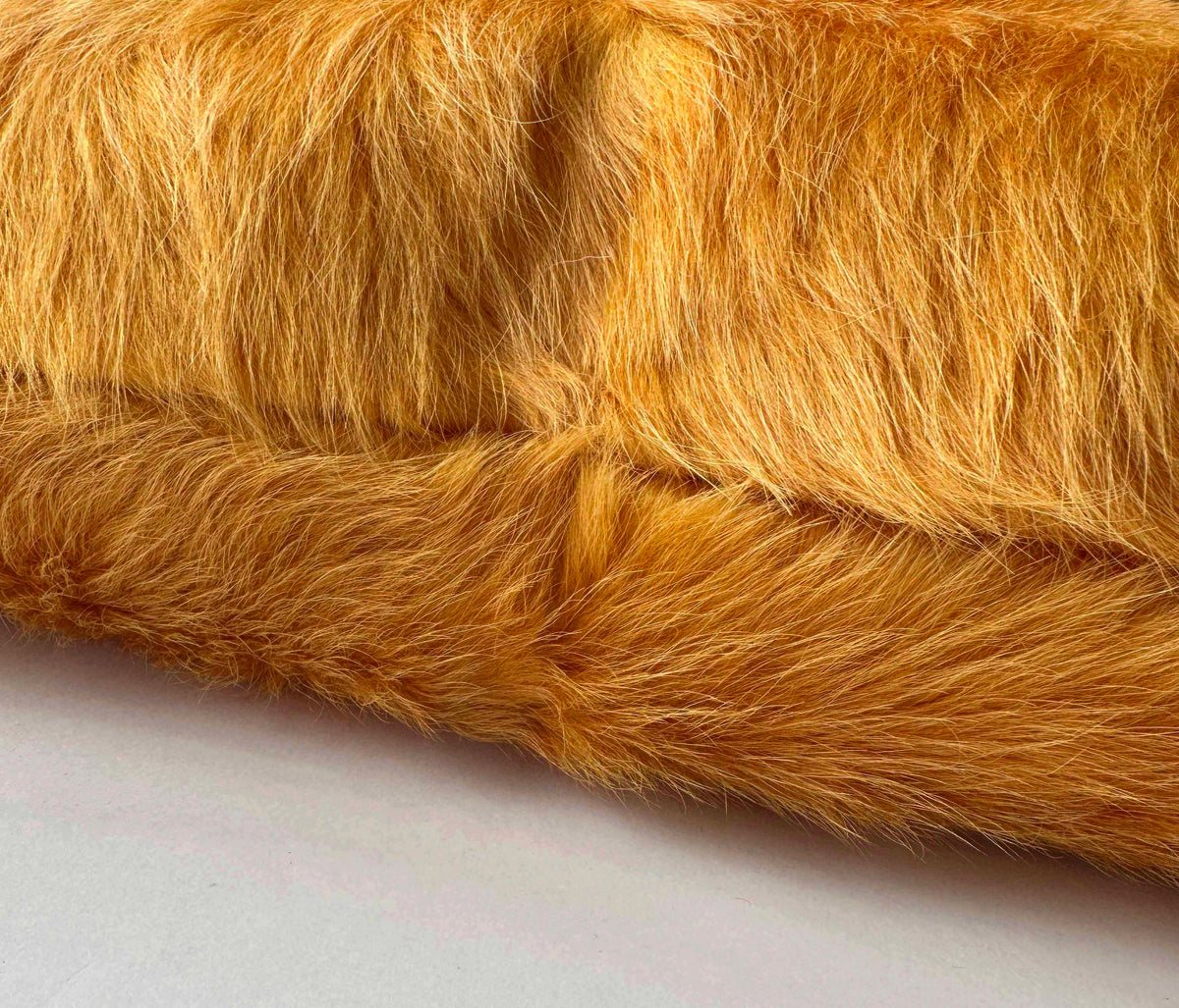 Marigold cowhide pillow detail with hidden zipper closure