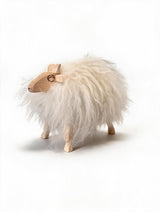 A small wooden sheep with a fluffy white fur body and a light natural wood head, legs, and horns, photographed on a clean white background.