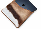 MacBook Air with a springbok leather case on a white background