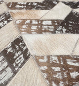 Close-up of Palermo’s light beige and stonewashed brown hair-on cowhide pieces, showing natural markings and zigzag stitching.
