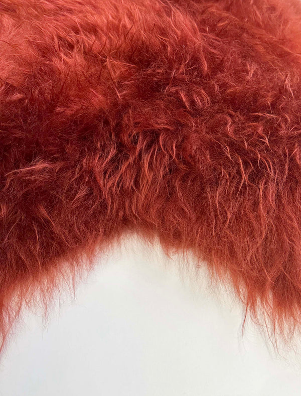 red sheepskin rug