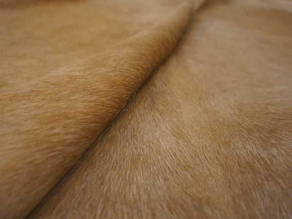 brown cowhide fur rug